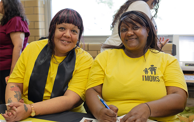 Photo of two women smiling for camera.