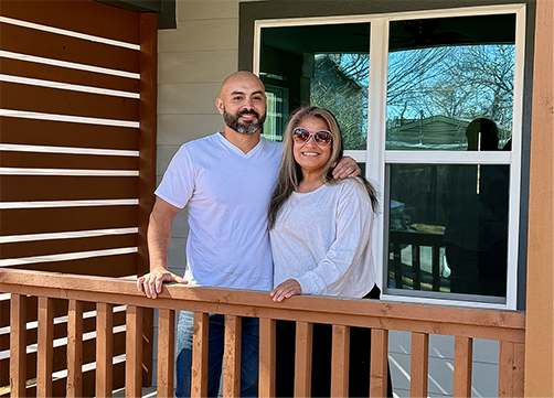 Photo of couple on front porch, smiling