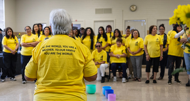 Photo of person speaking to group of people.