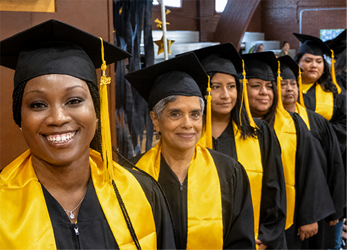 Photo of graduates smiling for camera