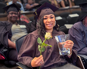 Photo of woman in cap and gown, graduating