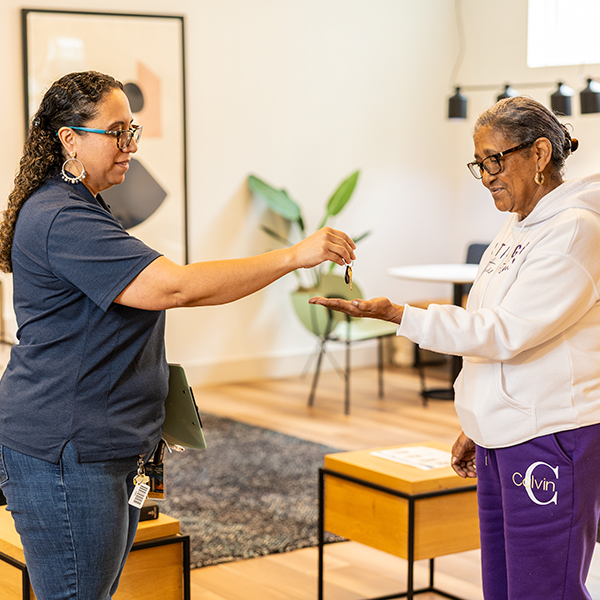 Photo of tenant receiving keys.